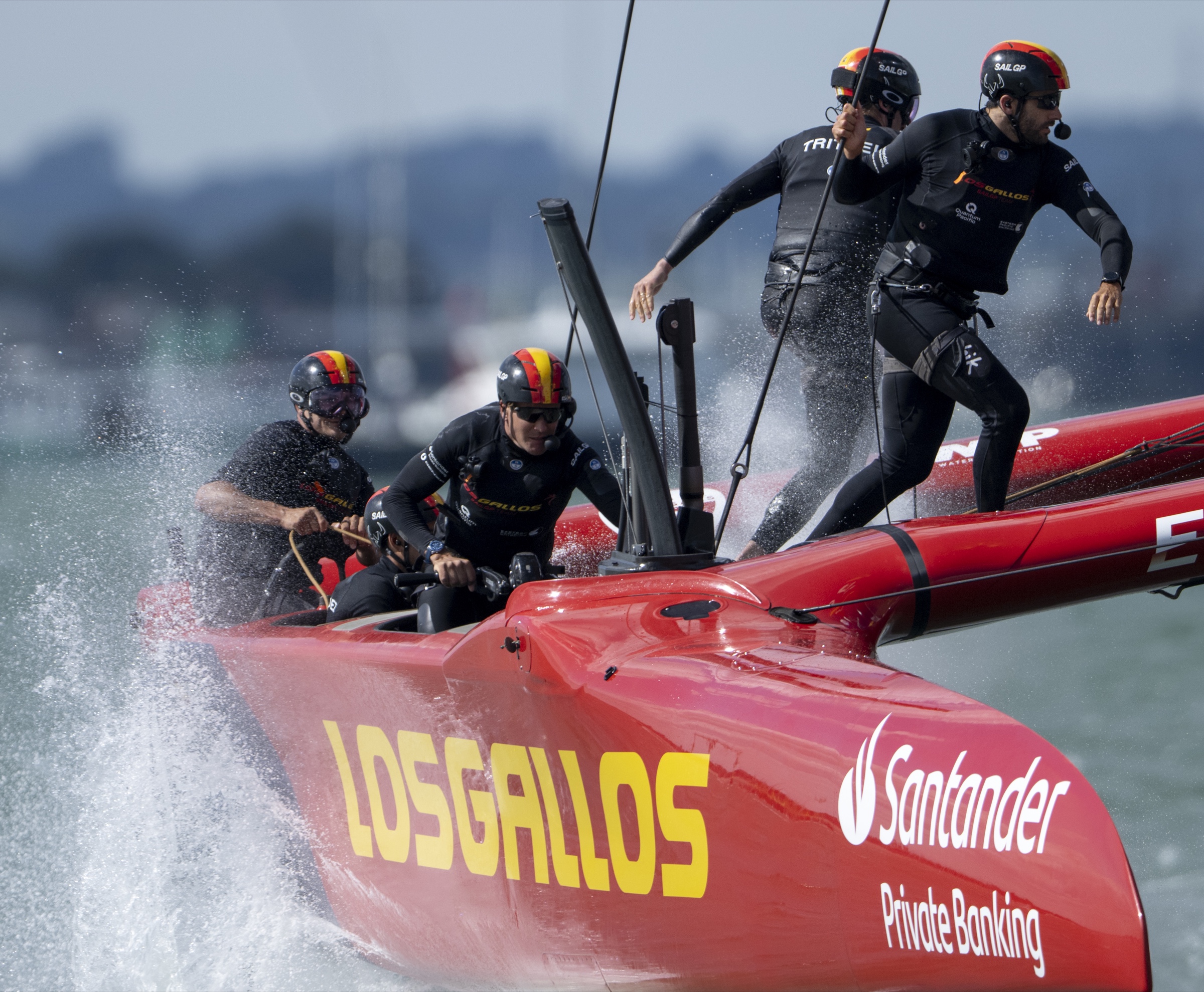 SailGP crew working together aboard a racing catamaran